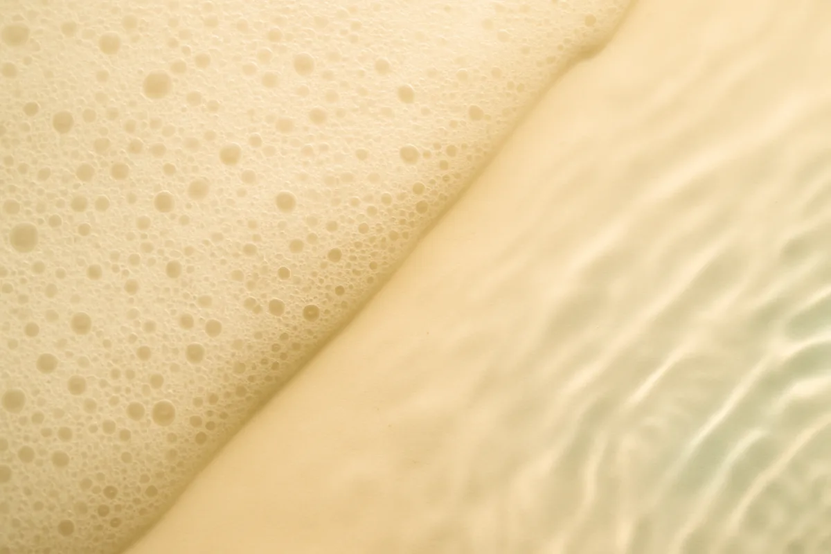 A cleanser texture shifting from lather to clear water